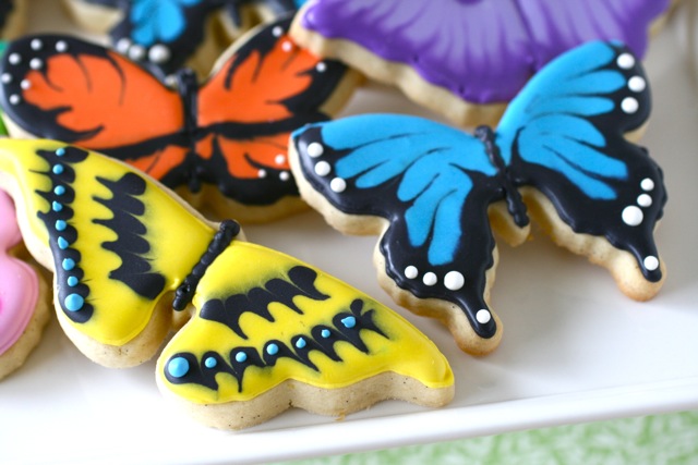 Professionally decorated butterfly sugar cookies that resemble monarch and swallowtail butterflies 