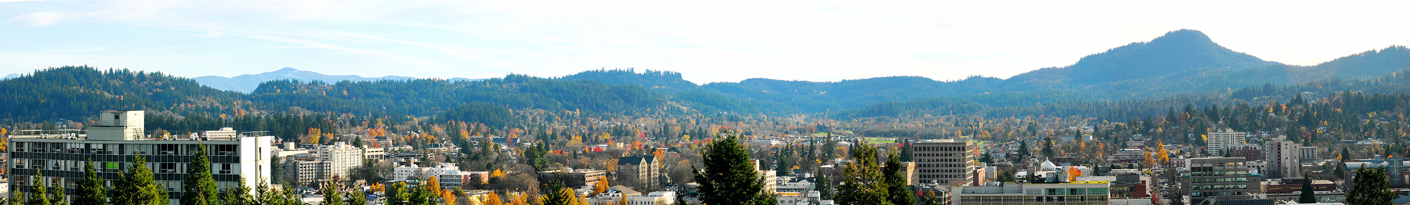 A panoramic shot shows the Eugene landscape, with low-lying buildings and hilly terrain in the distance.