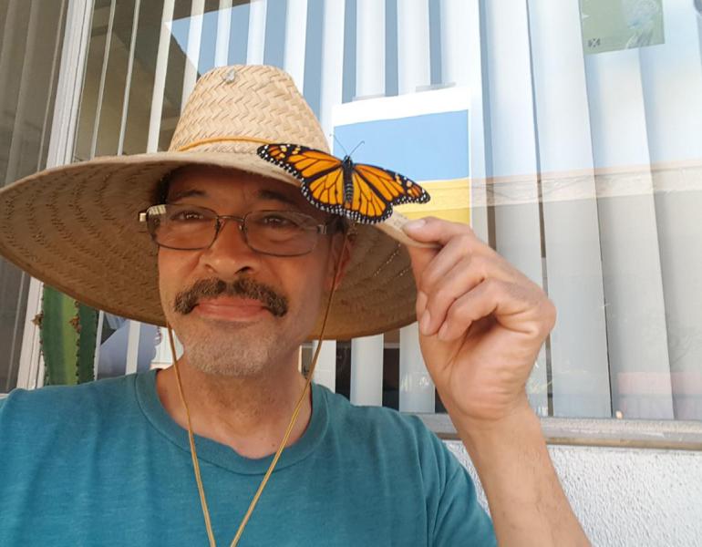 Xerces Society member Augustin Garnier with monarch butterfly on hat
