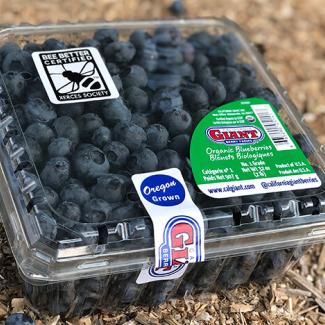 A plastic clamshell of blueberries bears the Bee Better Certified seal, as well as a label that says "Oregon grown" and the California Giant label.
