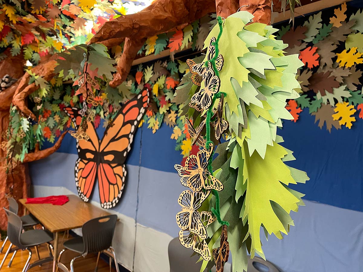 Wooden butterflies hanging from a giant paper tree