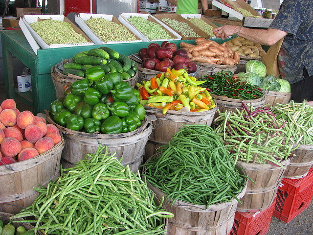 Baskets of colorful, fresh fruit and vegetables are shown.