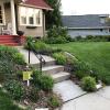 A pollinator habitat, with several native flowers, next to a grass lawn.