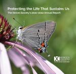 2021 Annual Report cover with a photo of a grey butterfly on a pink flower